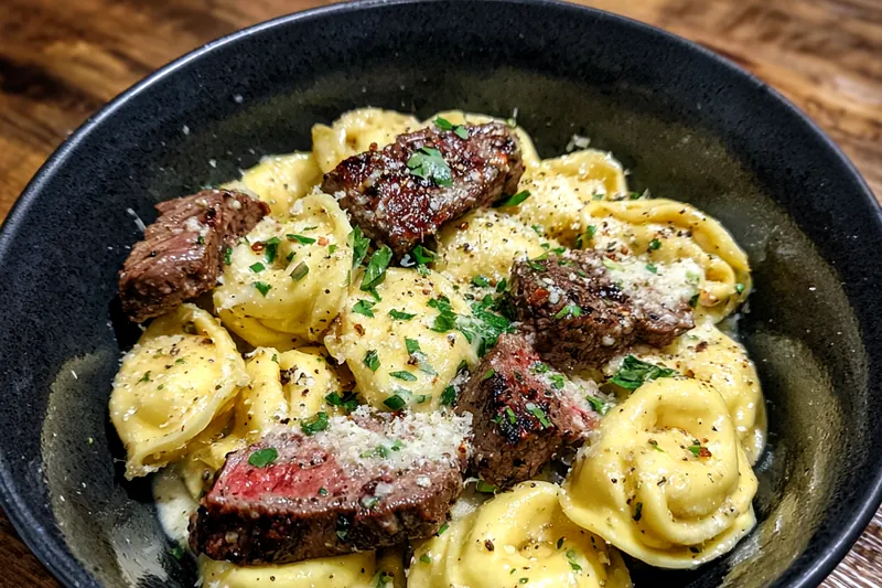 The process of cooking Creamy Garlic Steak Tortellini, showcasing sautéing steak and preparing the creamy sauce.